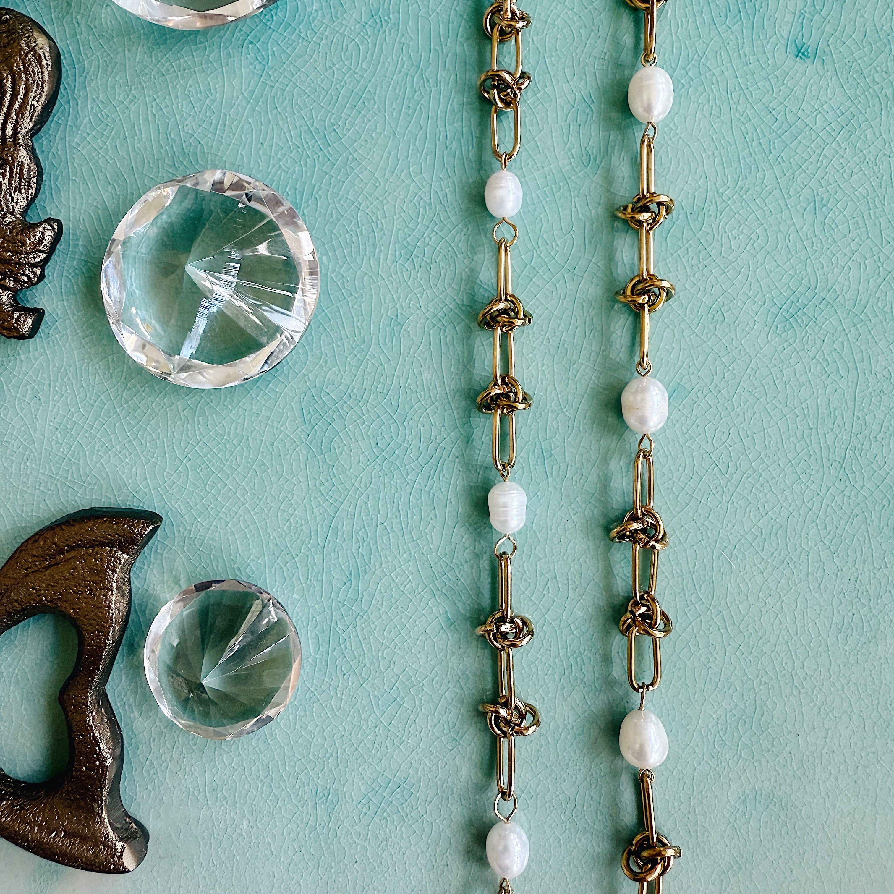 Freshwater pearl bracelet with gold accents on adjustable chain, styled for elegant, everyday wear.