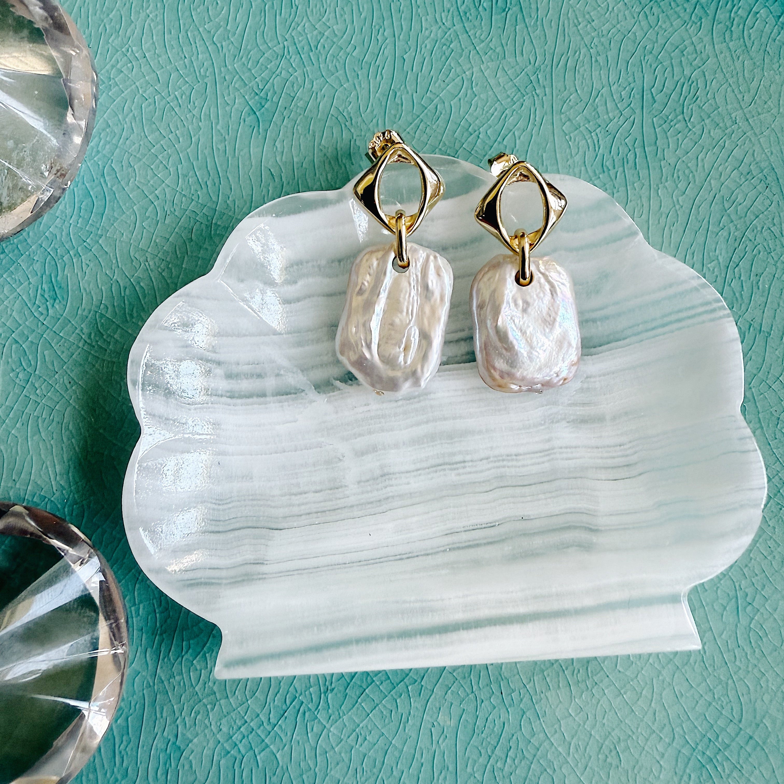Close-up of the Tyche Baroque Pearl Earrings with asymmetrical freshwater pearls on gold-plated sterling silver hooks, styled for elegant everyday wear.