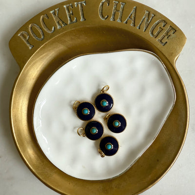 The Capri Charm by Wild Alabaster — gold-plated navy enamel pendant with turquoise center, modern evil eye protection jewelry.